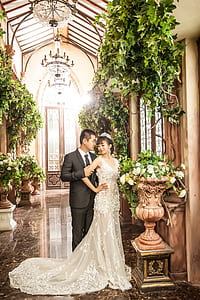 bride and groom inside church surrounded by green leaf plants thumbnail