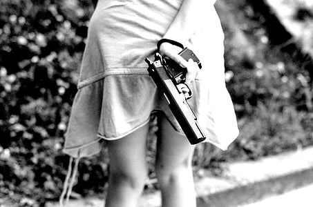 girl holding semi-automatic pistol thumbnail