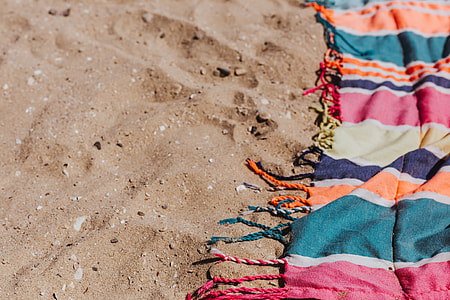 Colorful beach towel on the sand thumbnail