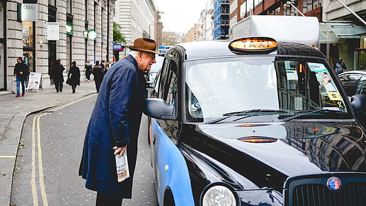 man beside taxi vehicle thumbnail