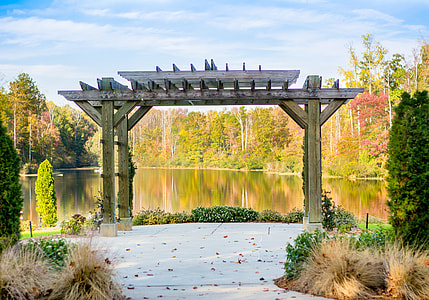 gray wooden arc near trees at daytime thumbnail