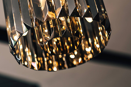 Elegant black designer chandelier with a lit lightbulb thumbnail