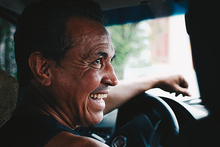 man in blue tank top inside car at daytime thumbnail