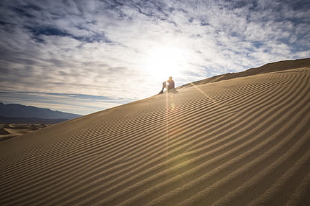 silhouette of person on sand dunes thumbnail