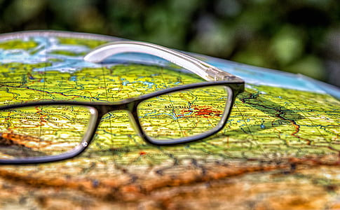 black framed eyeglasses on top of map thumbnail