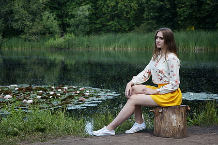 woman in white floral long-sleeved shirt and yellow mini skirt thumbnail
