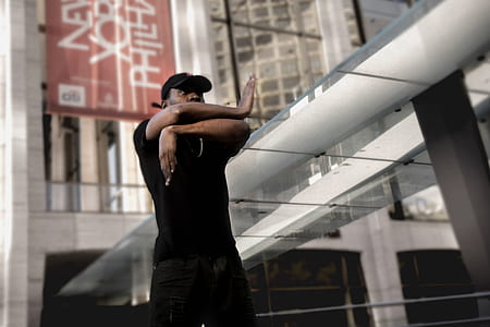 man standing near city buildings during daytime thumbnail