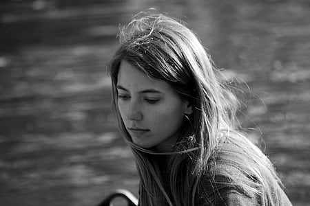grayscale photography of woman near body of water thumbnail