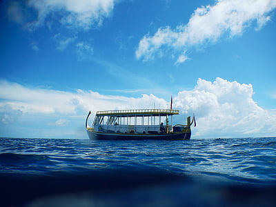 white boat on body of water under blue sky thumbnail