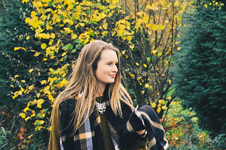 woman smiling near trees thumbnail