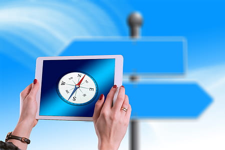 person holding iPad with compass on monitor thumbnail