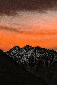rock formation mountain under orange clouds thumbnail