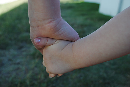 selective focus photo of two person holding each other's hand thumbnail