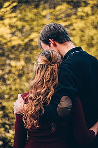 couple standing in front of green leafed tree shallow focus photography thumbnail