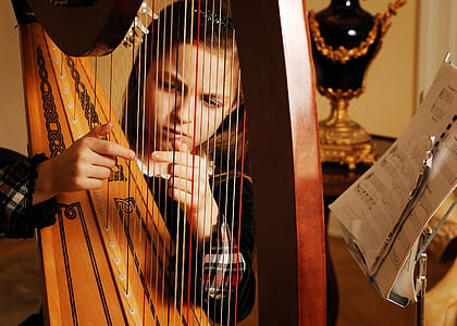 girl playing brown harp thumbnail
