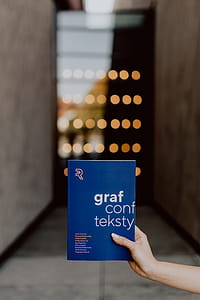 The woman is holding books in her hands thumbnail