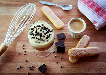 flatlay photography of glass of frappe beside chocolate and biscuits thumbnail