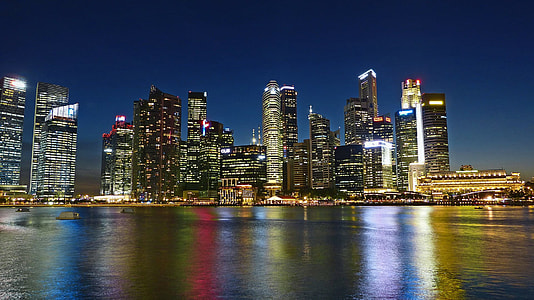 cityscape by water during nighttime thumbnail