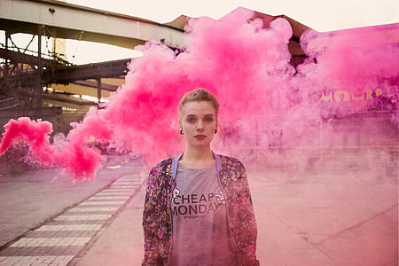 woman standing behind purple smoke thumbnail