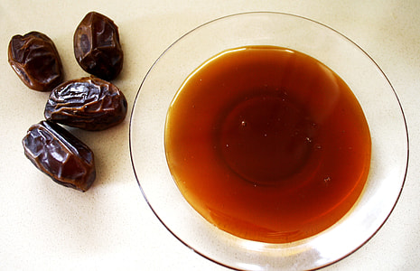 four date fruits beside white plate thumbnail