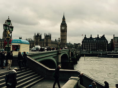 brown concrete bridge near Elizabeth Tower under gray skies thumbnail