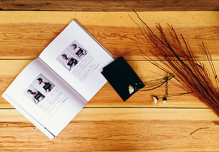 book and brown decorative plate top of desk thumbnail