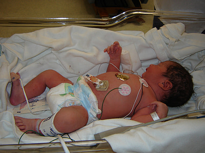 baby sleeps on white textile thumbnail