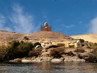 brown brick mosque under blue clear sky during daytime thumbnail
