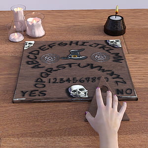 ouija board on brown table thumbnail