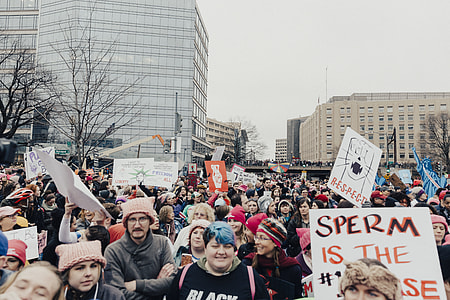 people gathering holding signage near the building thumbnail