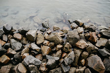 brown colored pebbles on seashore thumbnail