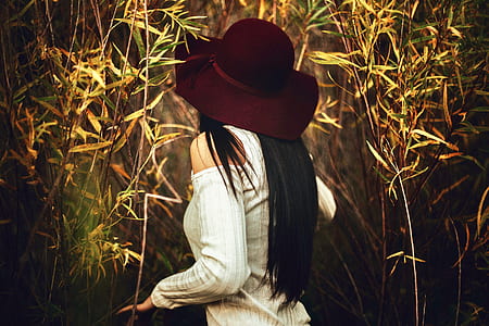 woman standing beside leafed trees thumbnail