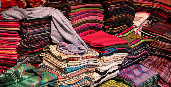 stack of assorted-color-and-pattern clothing items thumbnail
