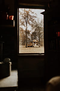brown and white wooden trailer trailer house under green leafed tree thumbnail