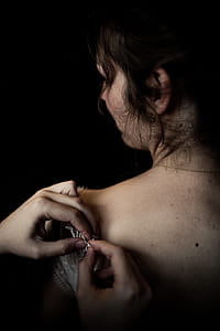 Person Fixing Woman's Lace Dress thumbnail