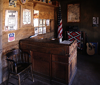 brown wooden desk white chair near USA flag thumbnail