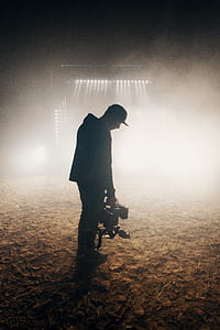 man in black jacket holding power tool thumbnail