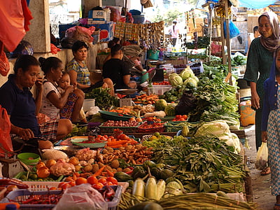 woman standing beside vegetables store thumbnail