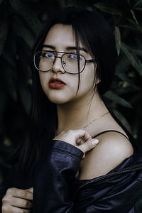 woman wearing black leather jacket and posing for photo thumbnail