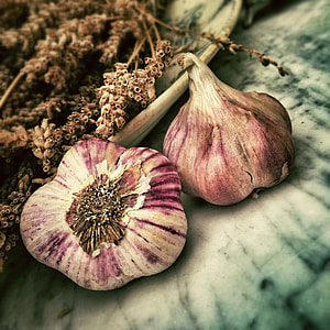 two garlic bulbs on top of white surface thumbnail