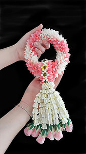 person holding pink, white, and green wreath thumbnail