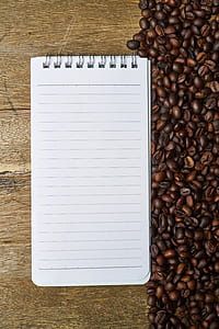white ruled paper beside coffee beans thumbnail