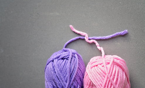 two purple and pink yarns on gray surface thumbnail