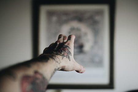 person pointing hand to painting thumbnail