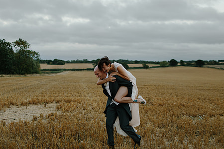 man and woman running on brown grass field thumbnail