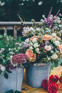 assorted flowers in grey metal buckets thumbnail
