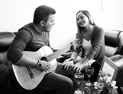 man playing guitar in front of girl thumbnail