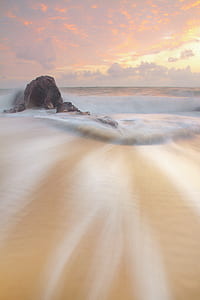 Brown Sand Beside Brown Rock during Daytime thumbnail
