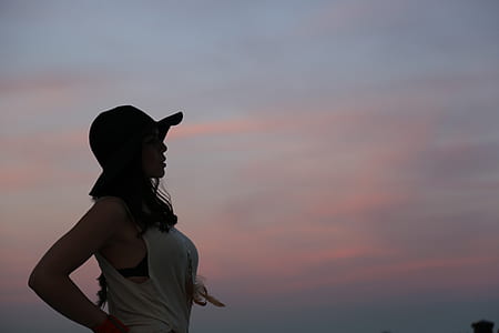 standing woman looking at the sky during sunset thumbnail