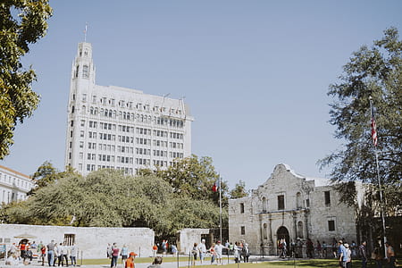people standing near white concrete buildings at daytime thumbnail